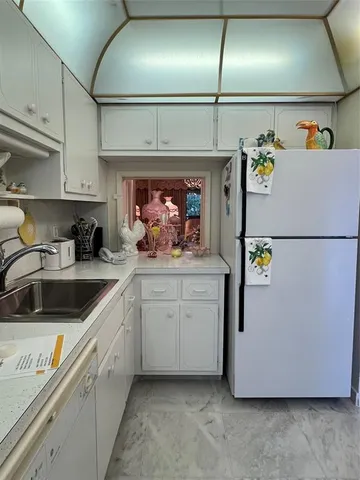 a kitchen with a refrigerator and a sink