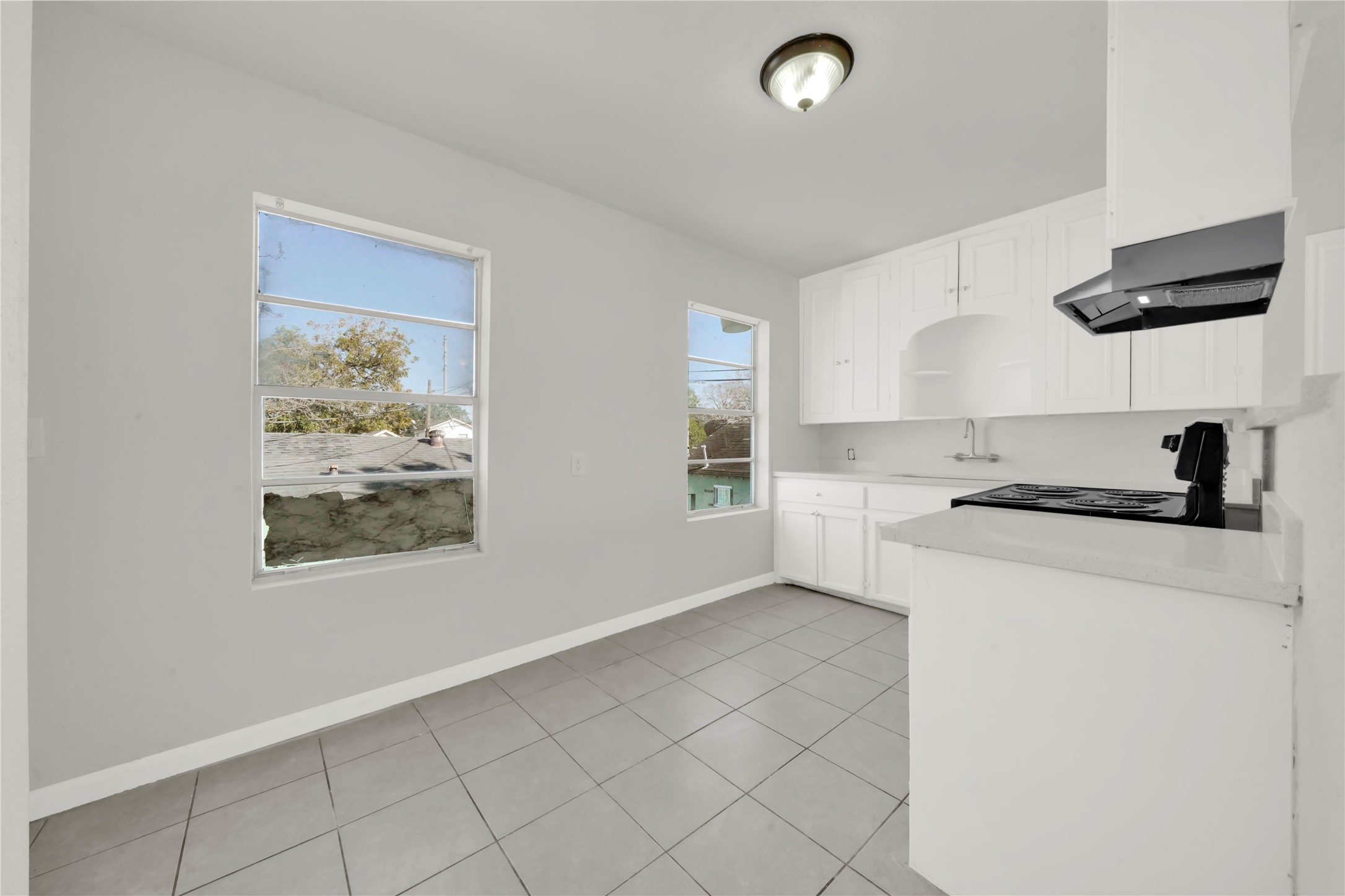 106 Hanover Street Houston, TX 77012 - Photo 40 of 49 a kitchen with a refrigerator a stove top oven a sink and a window