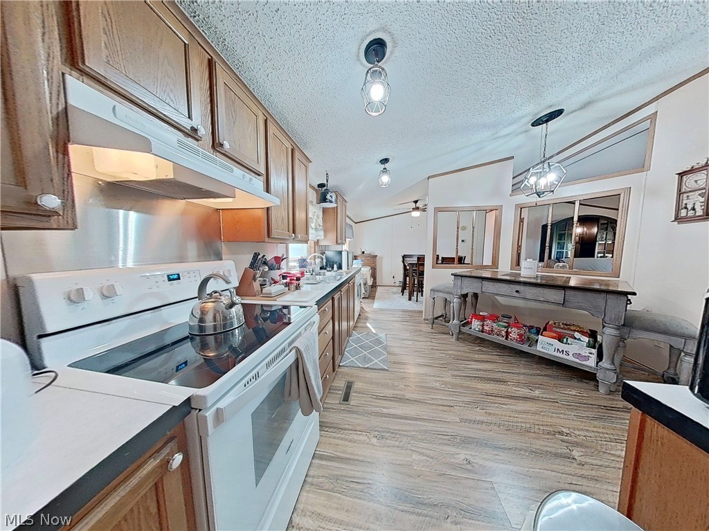 17015 McIntosh Road Wellsville, OH 43968 - Photo 8 of 24 Eat-in kitchen with updated flooring, abundant cabinet space, and an adjacent dining area.