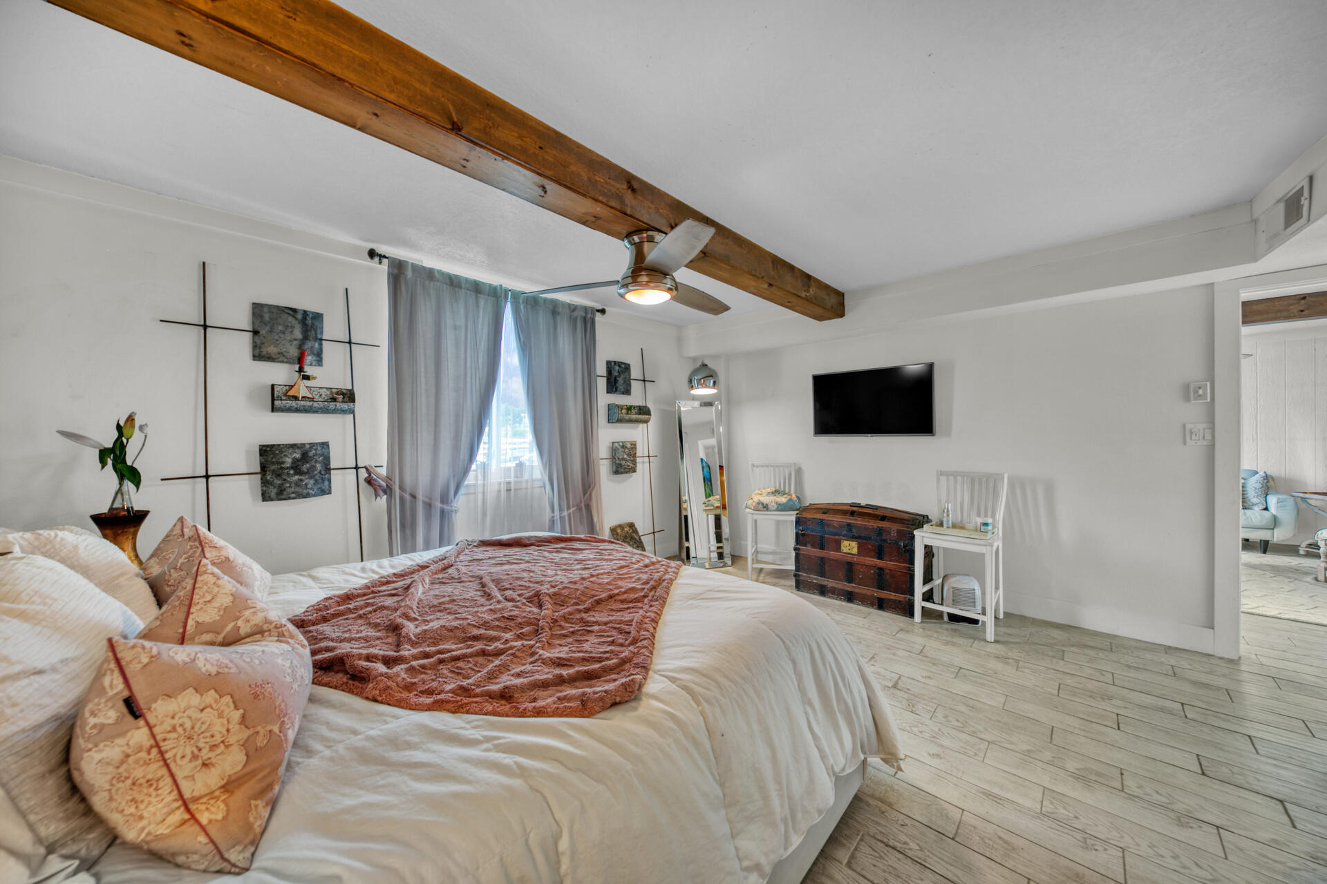 30 Moreno Point Road, Unit 101A Destin, FL 32541 - Photo 11 of 25 a spacious bedroom with a bed and a flat screen tv