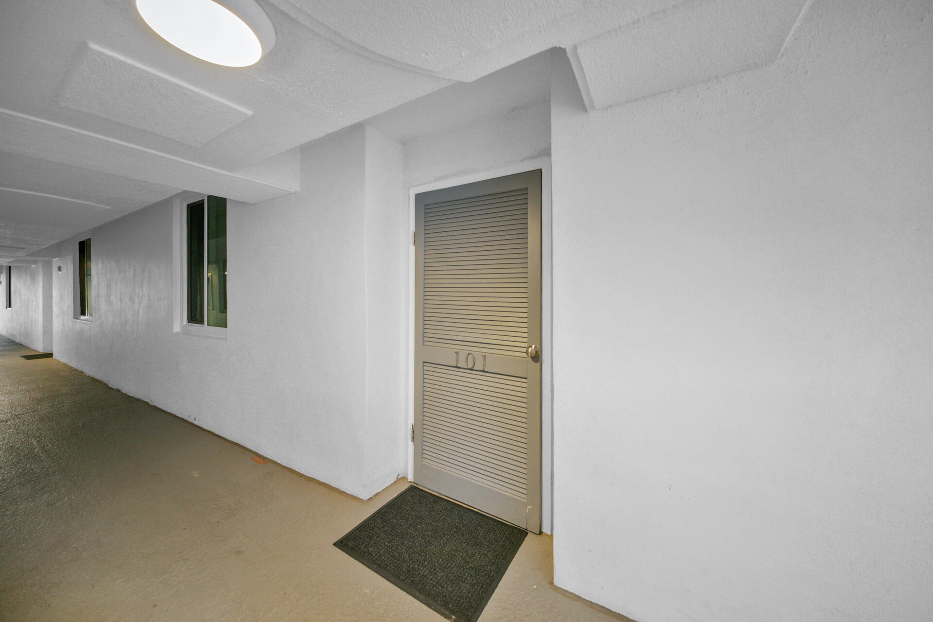 30 Moreno Point Road, Unit 101A Destin, FL 32541 - Photo 16 of 25 an empty room with windows