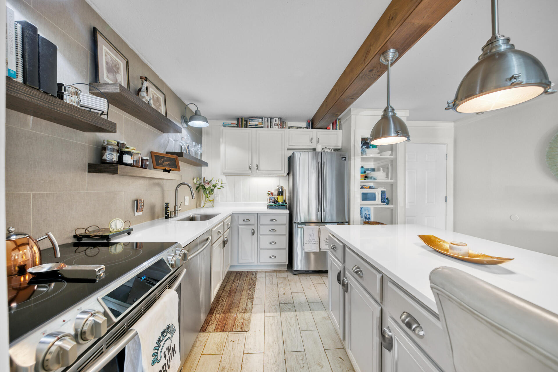 30 Moreno Point Road, Unit 101A Destin, FL 32541 - Photo 3 of 25 a kitchen with a sink appliances and cabinets