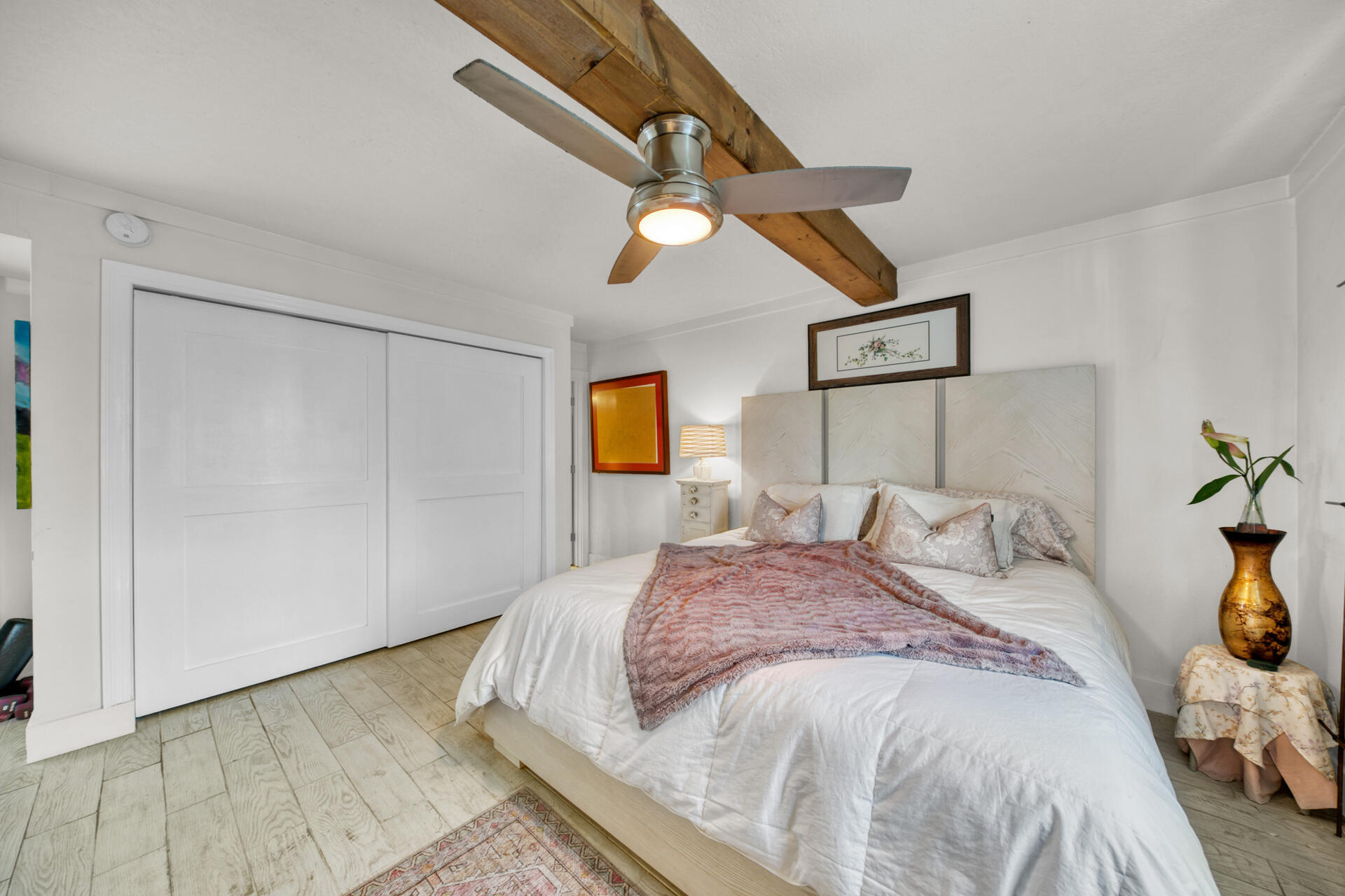 30 Moreno Point Road, Unit 101A Destin, FL 32541 - Photo 10 of 25 a bedroom with a bed and a painting on the wall