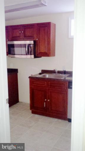 5114 Sheriff Road Northeast Washington, DC 20019 - Photo 3 of 7 a room with a cabinets and a fireplace