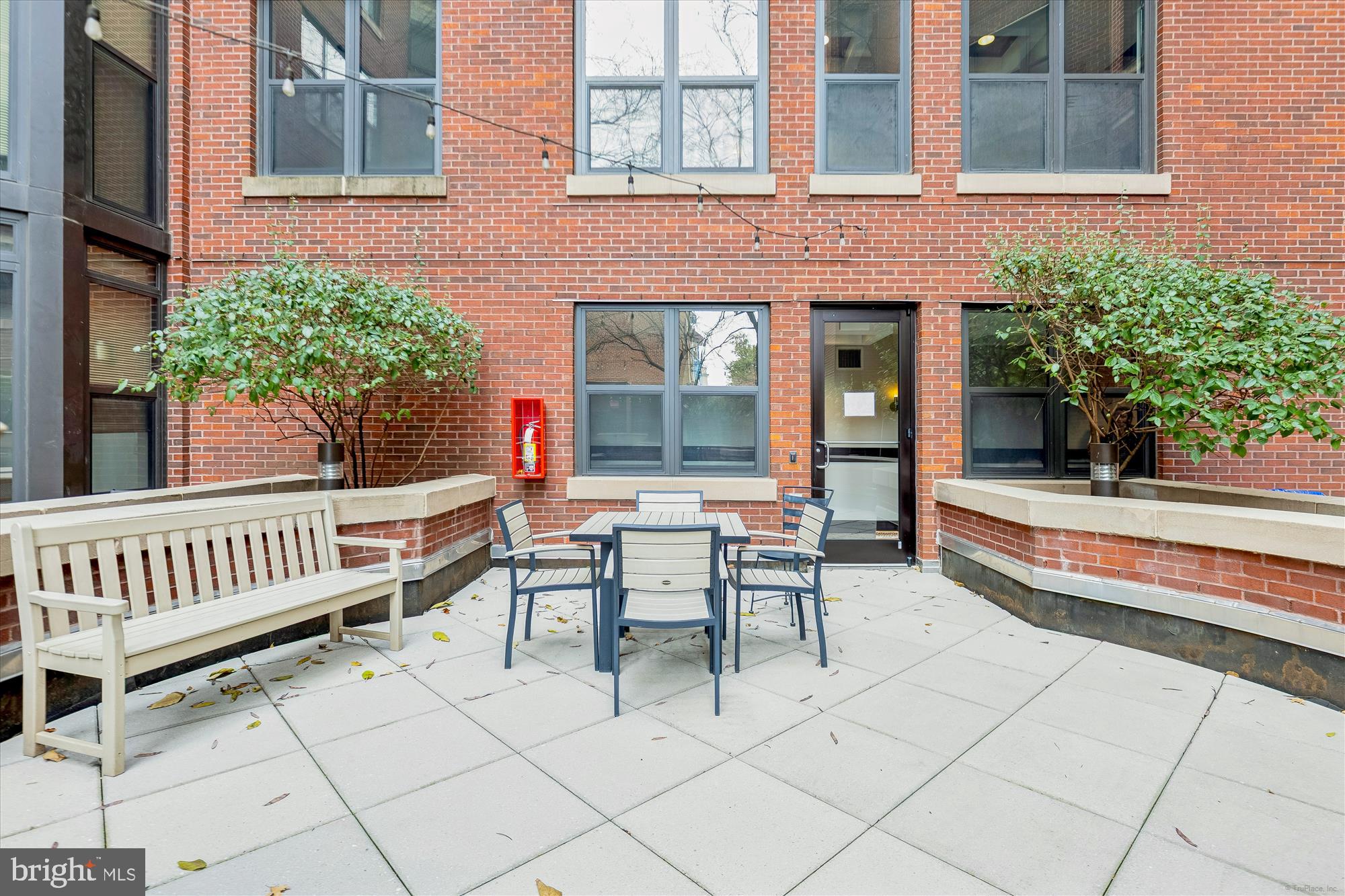 1390 Kenyon Street Northwest, Unit 416 Washington, DC 20010 - Photo 52 of 58 a view of a patio with a table and chairs