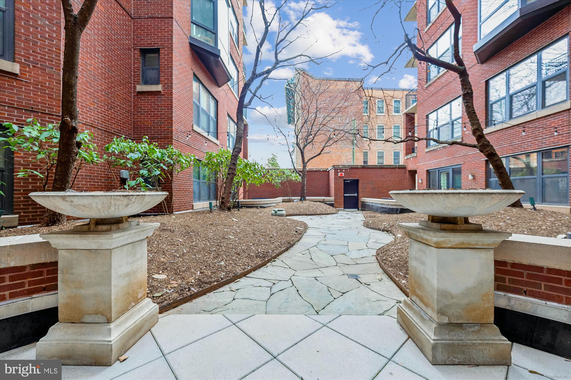 1390 Kenyon Street Northwest, Unit 416 Washington, DC 20010 - Photo 53 of 58 a view of a house with a yard and potted plants