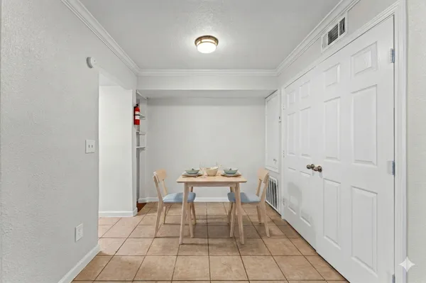 a dining room with furniture and wooden floor