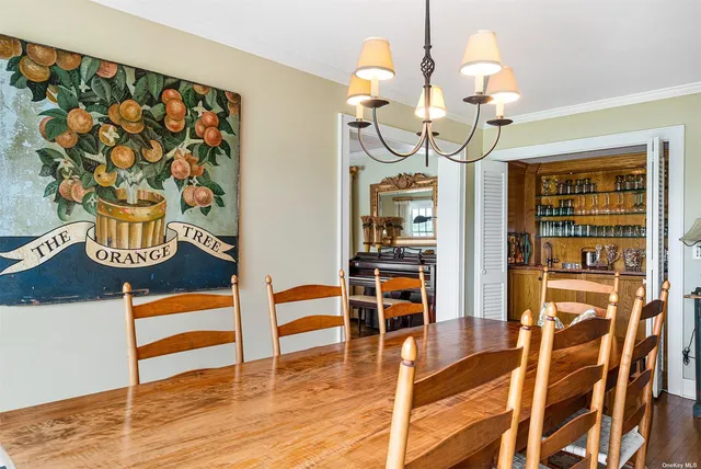 a kitchen with stainless steel appliances granite countertop a table and chairs in it