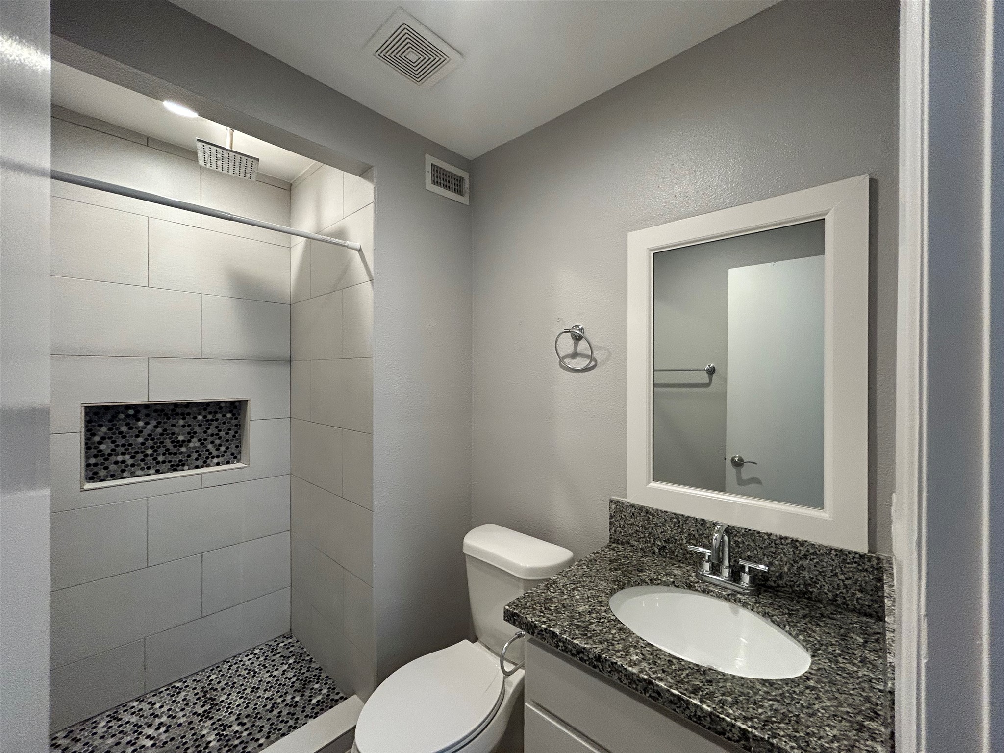 2810 Beauchamp Street, Unit 19 Houston, TX 77009 - Photo 17 of 21 a bathroom with a granite countertop sink toilet a mirror and shower