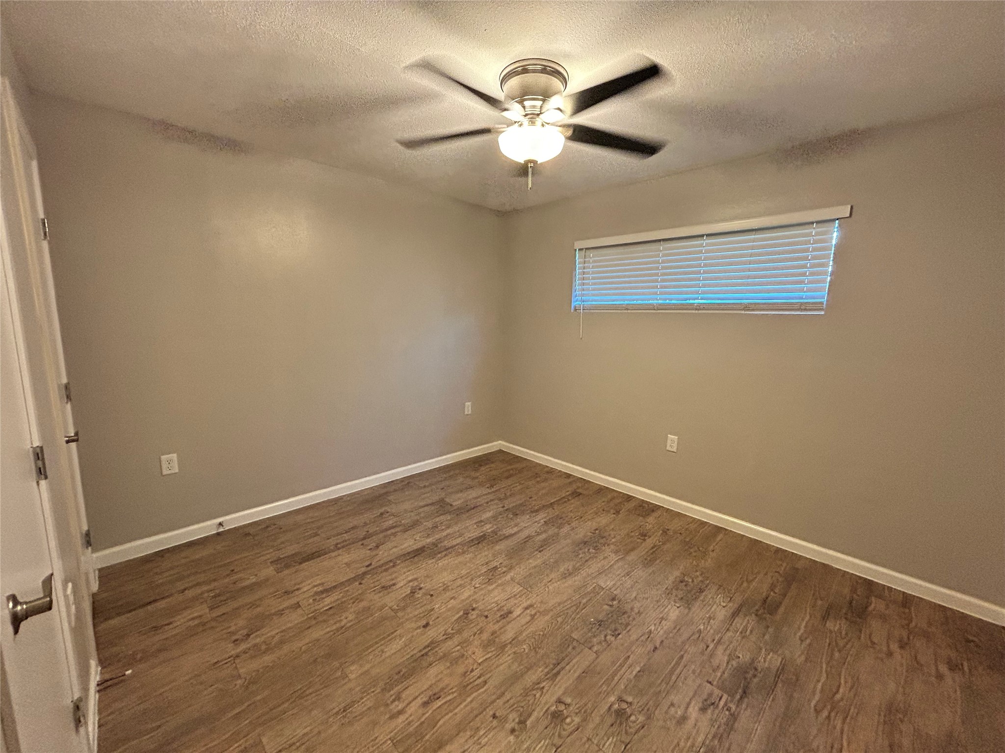 2810 Beauchamp Street, Unit 19 Houston, TX 77009 - Photo 18 of 21 an empty room with a chandelier fan and windows