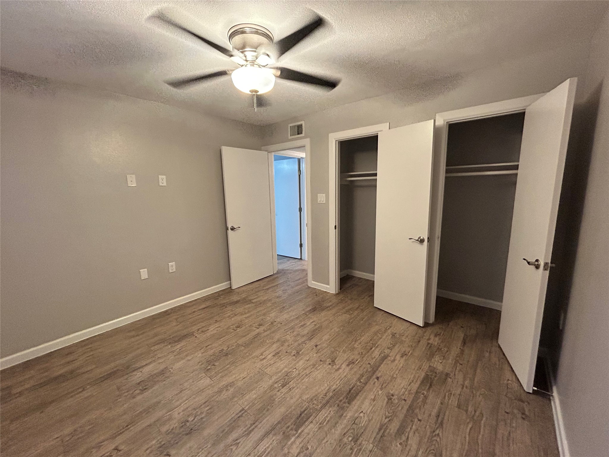 2810 Beauchamp Street, Unit 19 Houston, TX 77009 - Photo 21 of 21 an empty room with wooden floor and a ceiling fan