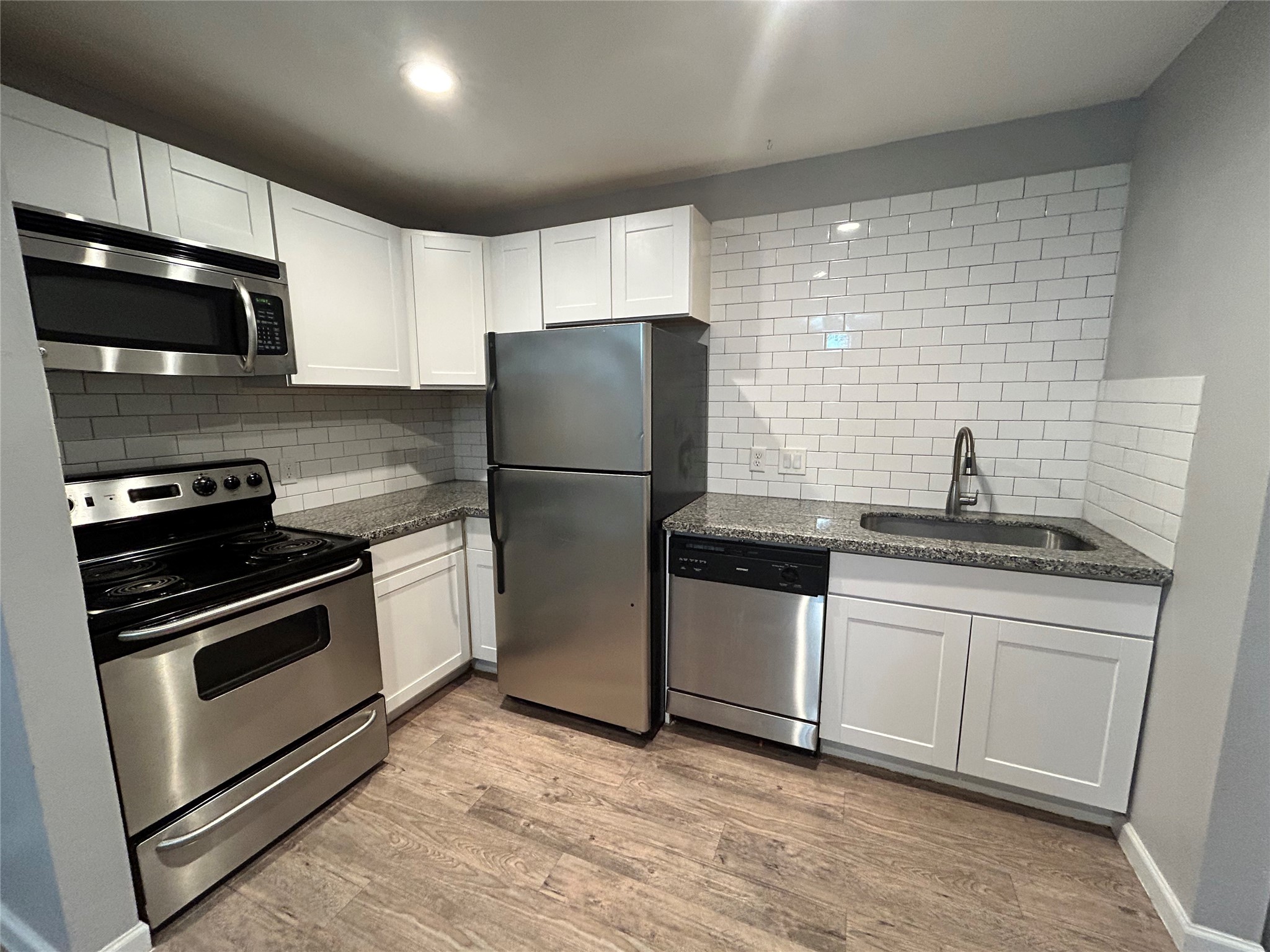 2810 Beauchamp Street, Unit 19 Houston, TX 77009 - Photo 8 of 21 a kitchen with stainless steel appliances a sink a stove a microwave and cabinets