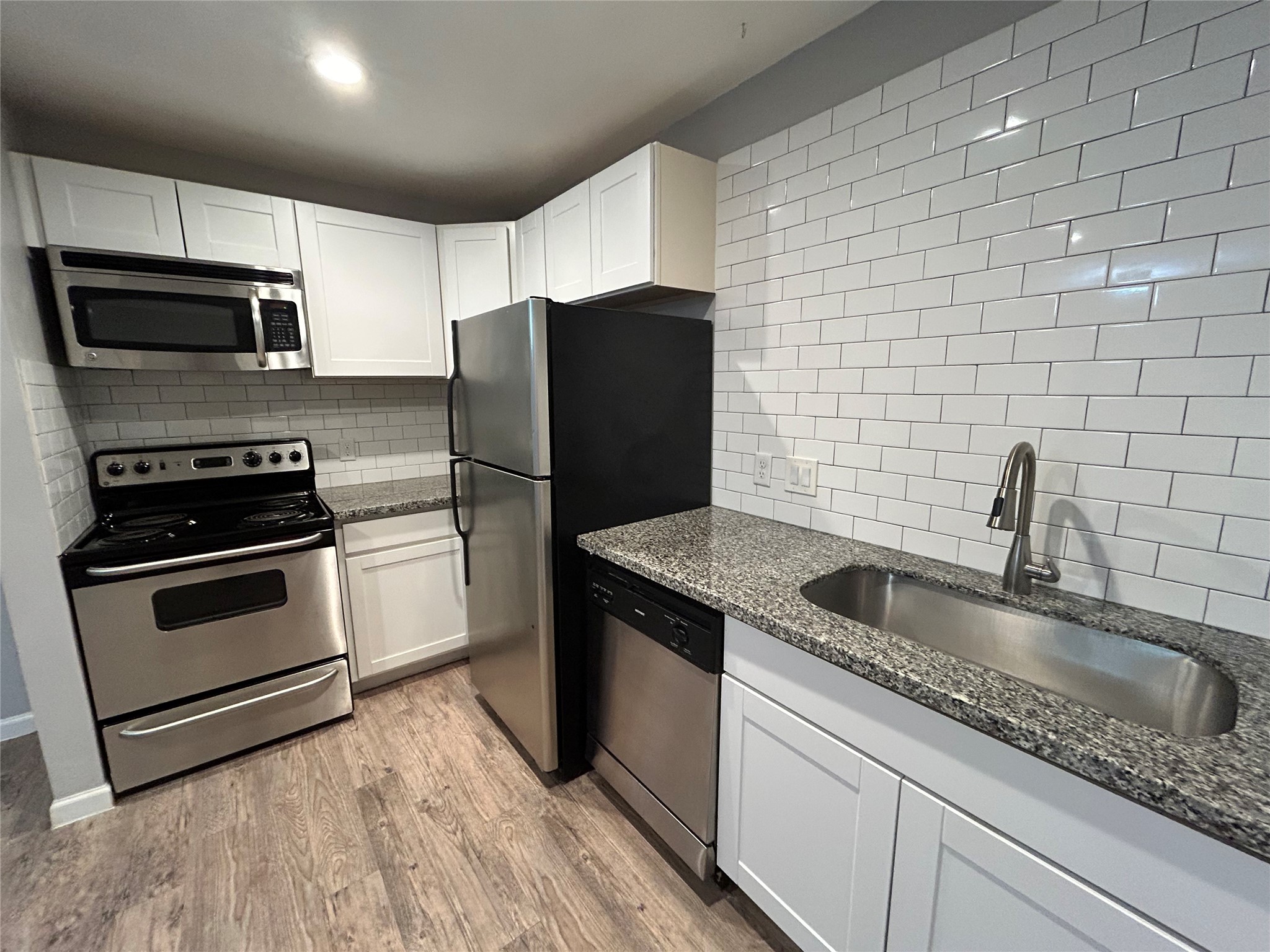 2810 Beauchamp Street, Unit 19 Houston, TX 77009 - Photo 9 of 21 a kitchen with stainless steel appliances granite countertop a sink stove and refrigerator