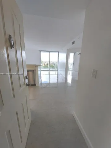 a view of an empty room with a fireplace