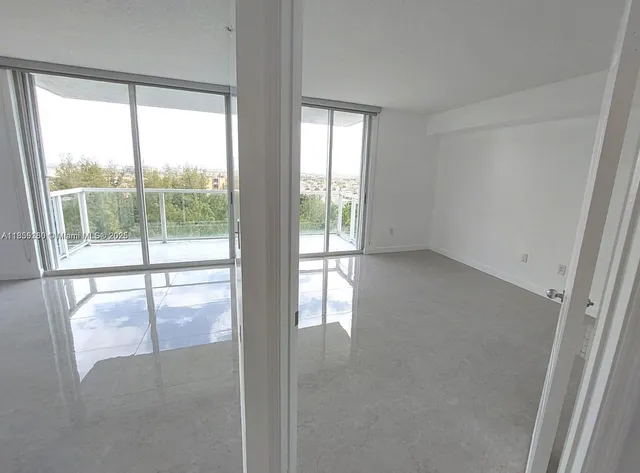 a view of an empty room with a window