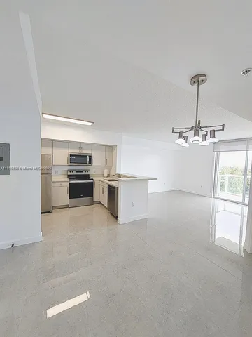 a view of kitchen with furniture and stainless steel appliances