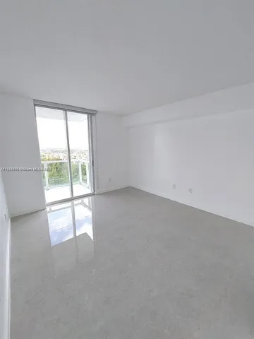 an empty room with an outdoor view and a window