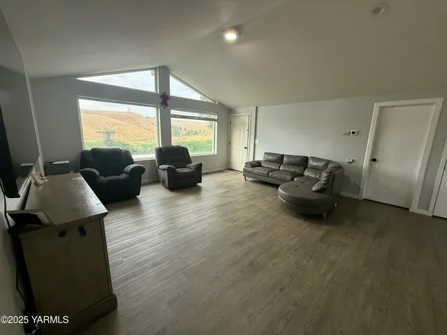 a living room with furniture window and a flat screen tv
