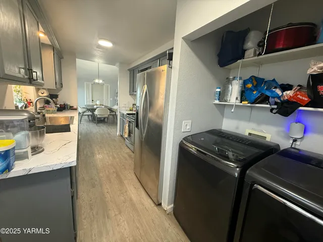 a kitchen with stainless steel appliances granite countertop a refrigerator stove and sink