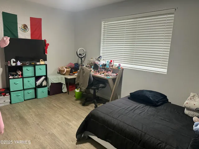 a bedroom with a bed and a window