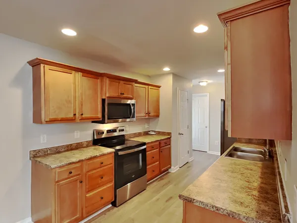 a kitchen with a stove a sink and a refrigerator