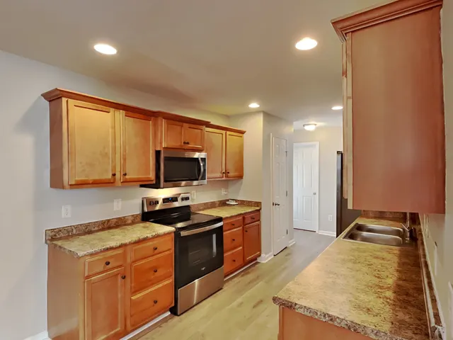 a kitchen with a stove a sink and a refrigerator