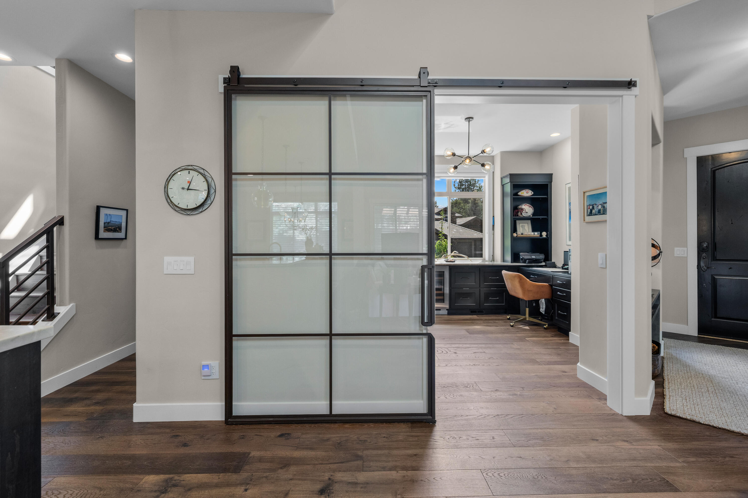 19460 Chip Shot Lane Bend, OR 97702 - Photo 21 of 56 A dramatic sliding glass door adds architectural interest while allowing light to flow between the entry and the beautifully finished office beyond.