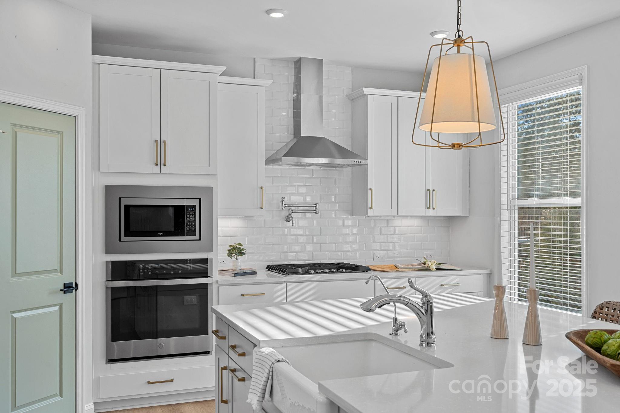 2253 Masons Bend Drive Fort Mill, SC 29708 - Photo 13 of 48 a kitchen with granite countertop a stove and a sink