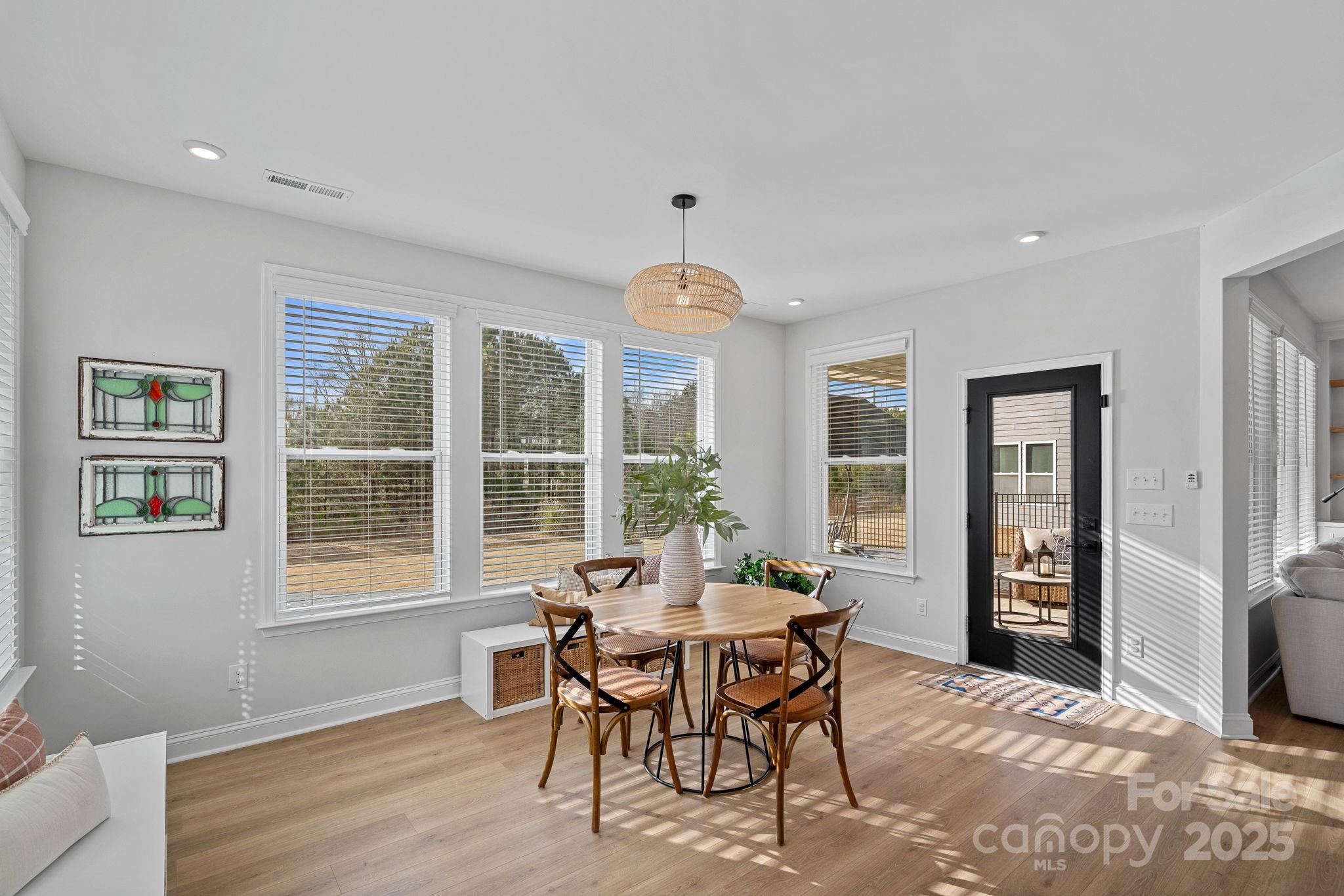 2253 Masons Bend Drive Fort Mill, SC 29708 - Photo 16 of 48 a dining room with furniture a chandelier and wooden floor