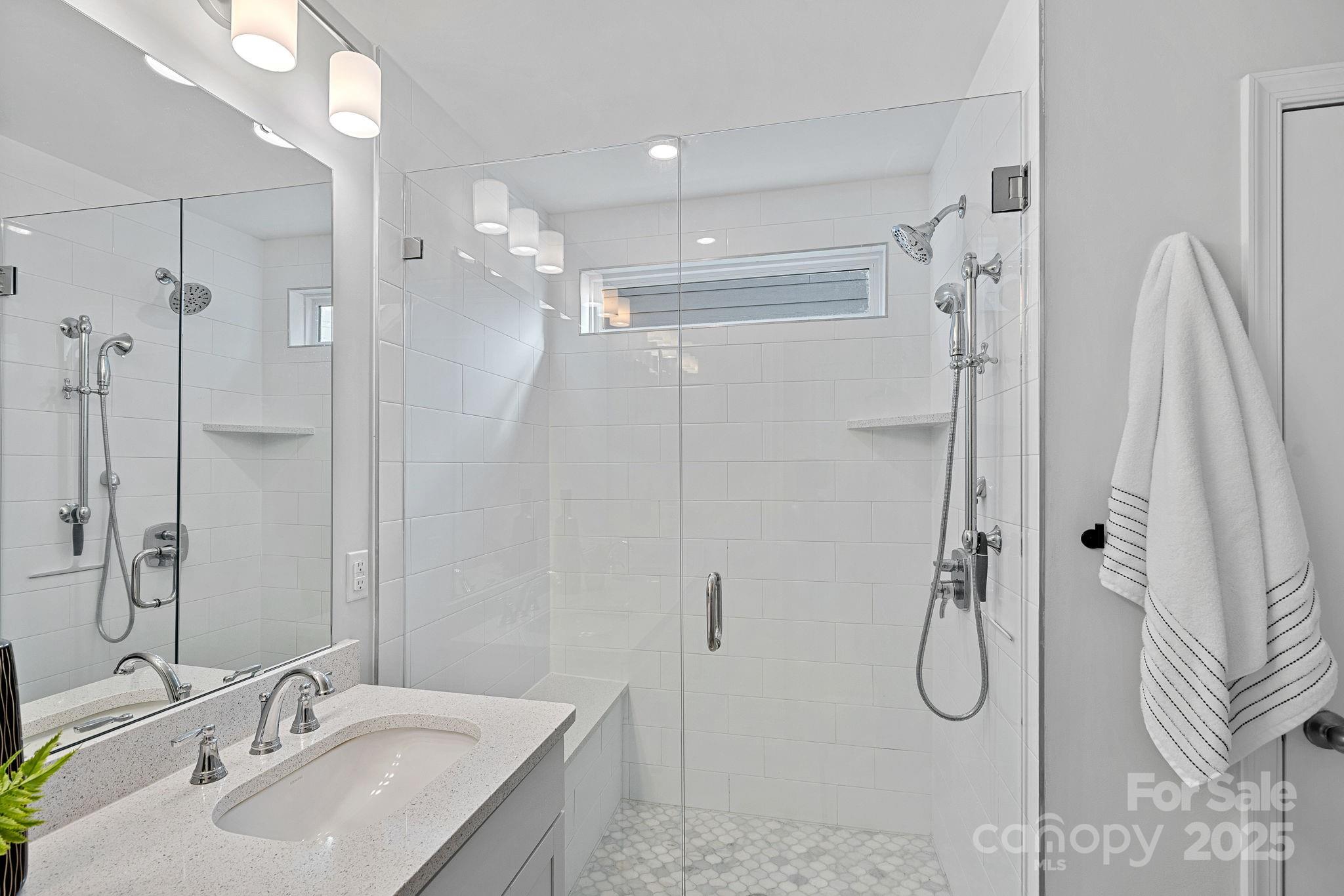 2253 Masons Bend Drive Fort Mill, SC 29708 - Photo 25 of 48 a bathroom with a sink vanity granite shower and a mirror