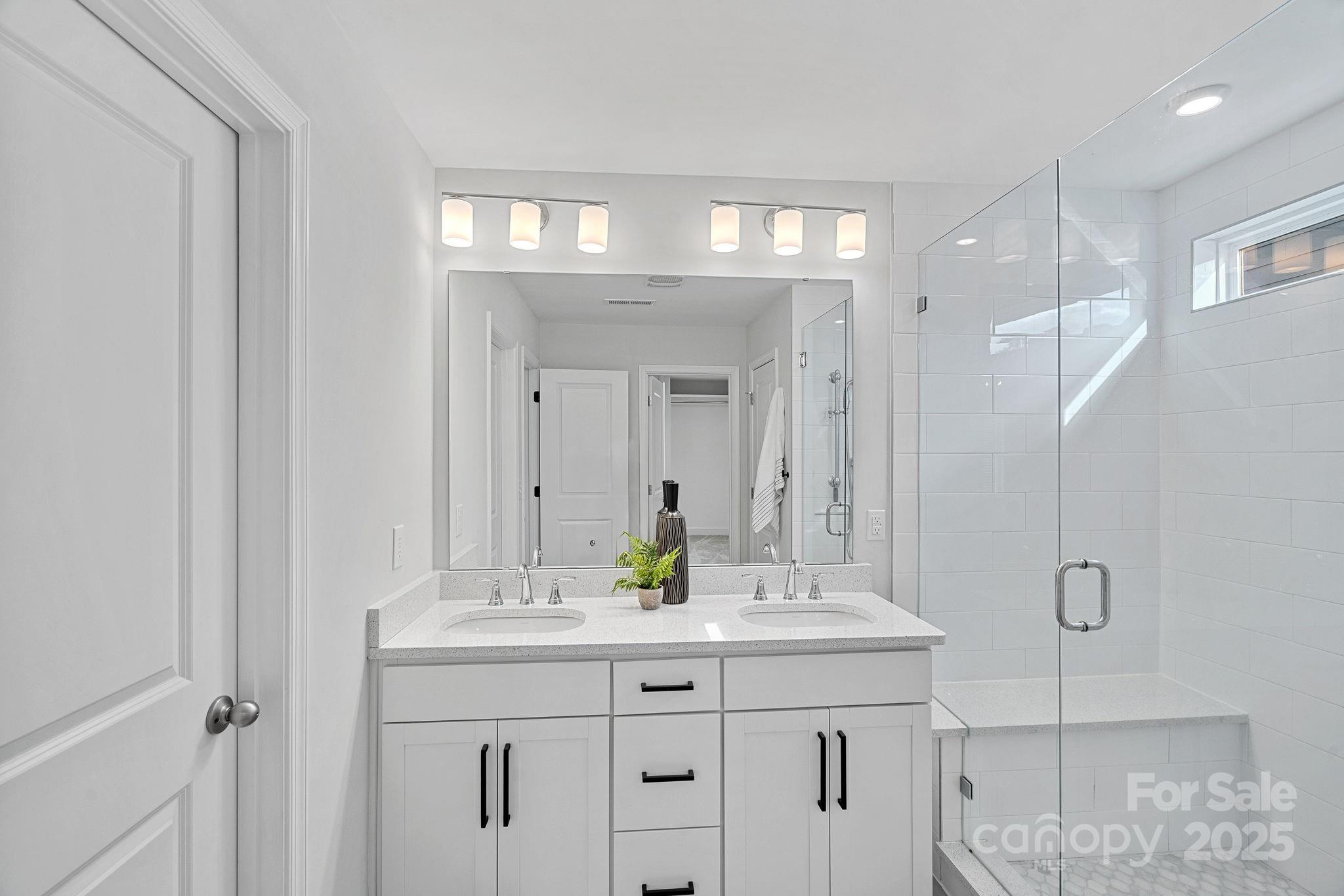 2253 Masons Bend Drive Fort Mill, SC 29708 - Photo 26 of 48 a bathroom with double vanity sink and a mirror