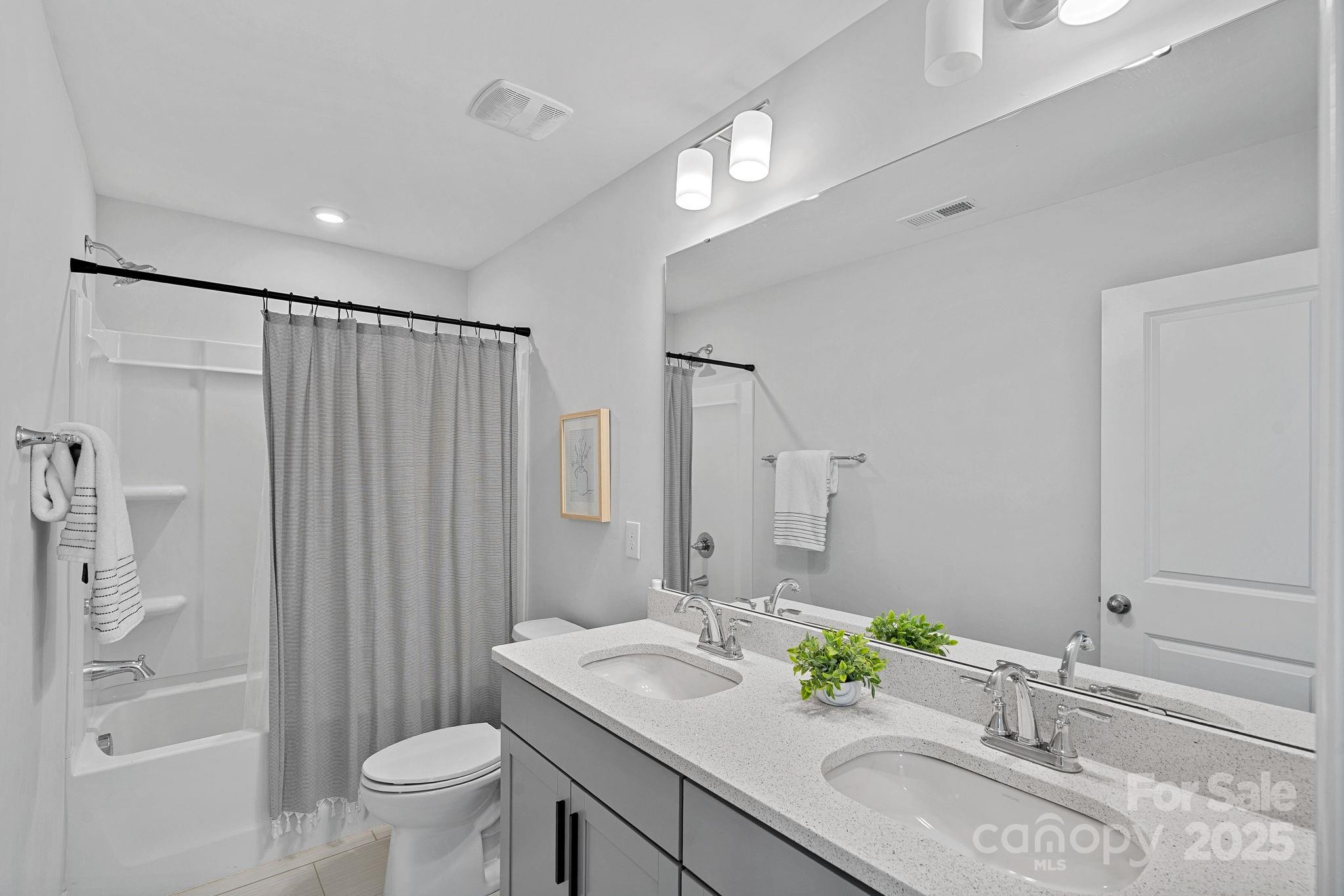 2253 Masons Bend Drive Fort Mill, SC 29708 - Photo 29 of 48 a bathroom with a granite countertop sink a toilet and shower