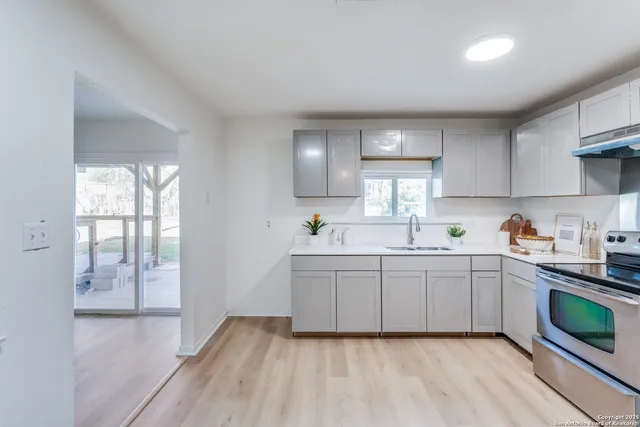 a kitchen with sink cabinets and window