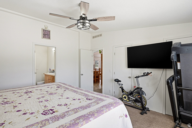 1637 East Midvalley Road Enoch, UT 84721 - Photo 17 of 48 Bedroom featuring light colored carpet, ceiling fan, a closet, and ensuite bathroom