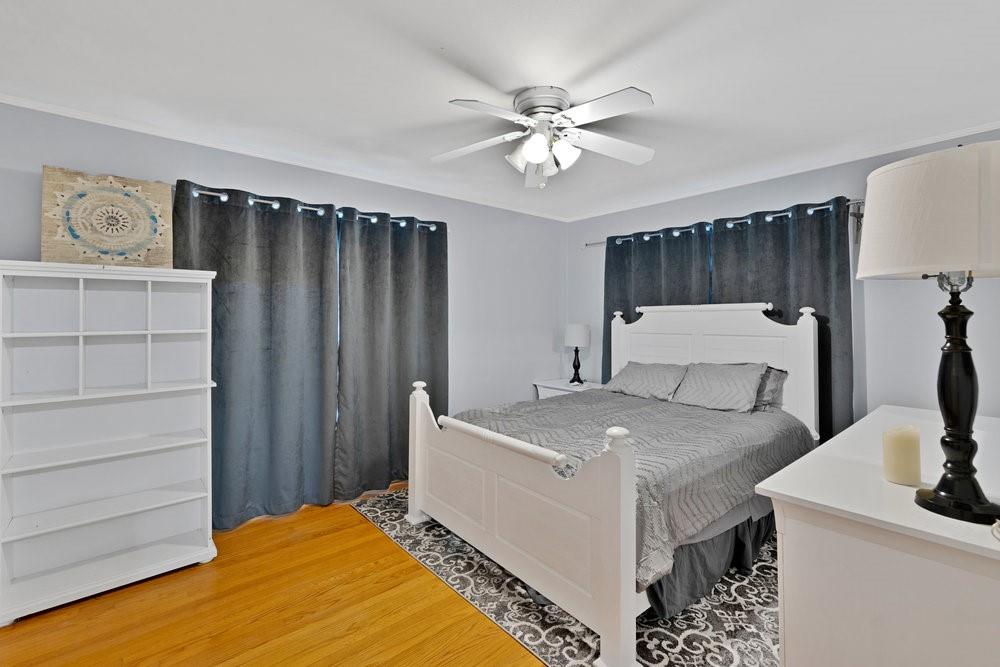 2716 Wayside Avenue Fort Worth, TX 76110 - Photo 14 of 34 a bedroom with a bed and a chandelier