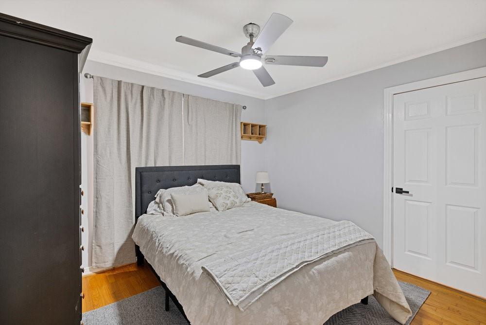 2716 Wayside Avenue Fort Worth, TX 76110 - Photo 16 of 34 a bedroom with a bed and a ceiling fan