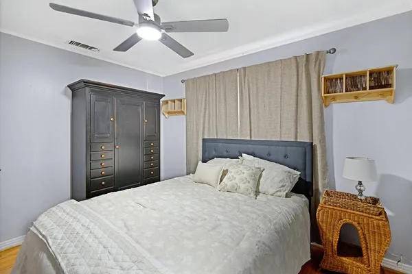 a bedroom with a bed and a chandelier