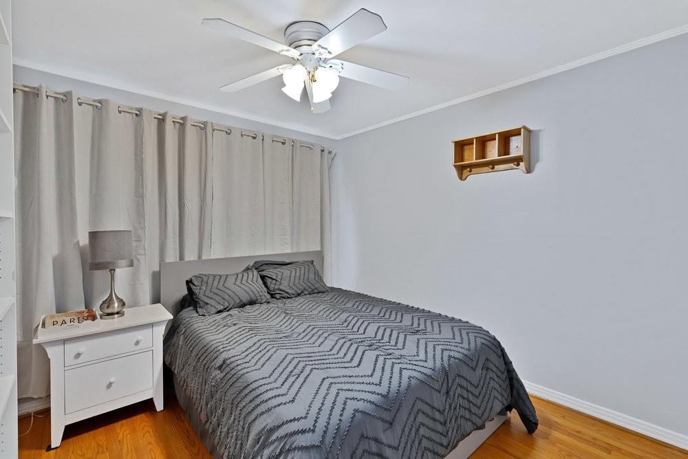 2716 Wayside Avenue Fort Worth, TX 76110 - Photo 18 of 34 a bedroom with a bed and a chandelier