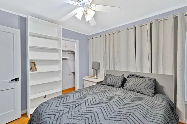 a bedroom with a bed and a chandelier