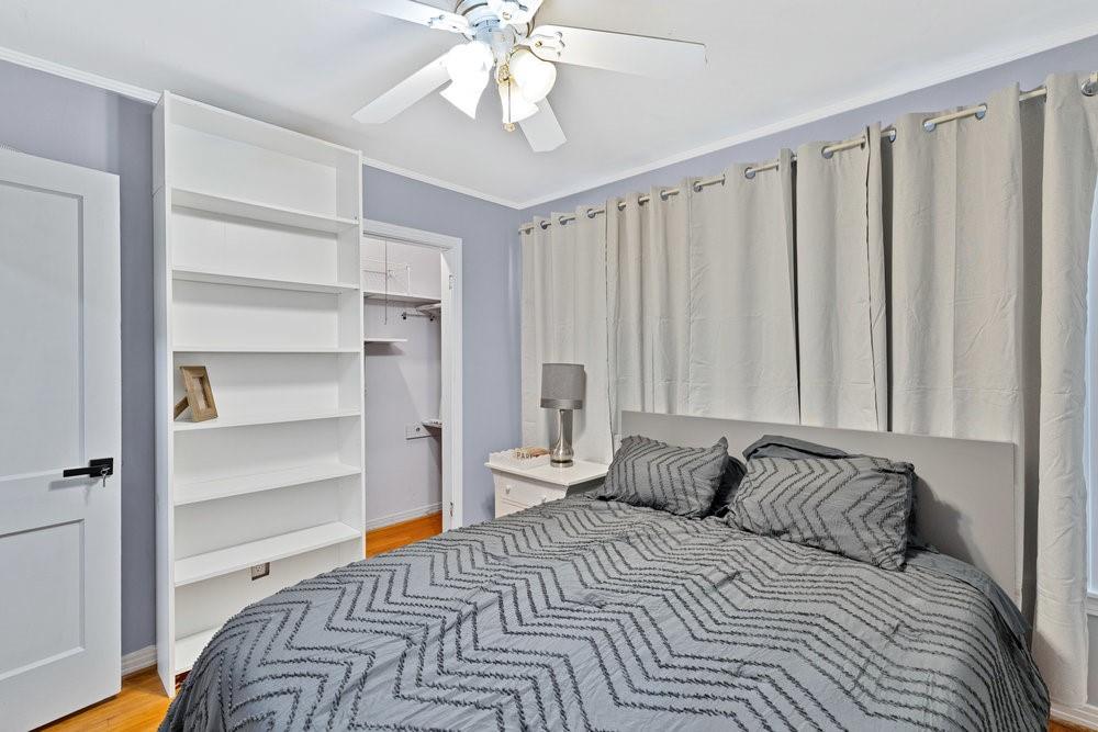 2716 Wayside Avenue Fort Worth, TX 76110 - Photo 19 of 34 a bedroom with a bed and a chandelier