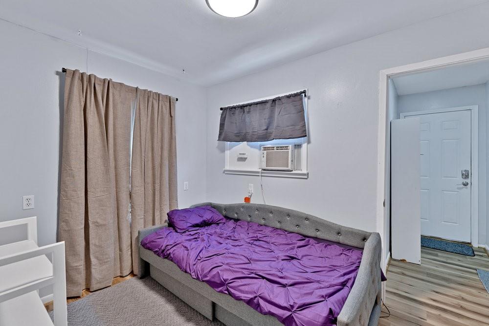 2716 Wayside Avenue Fort Worth, TX 76110 - Photo 21 of 34 a bed sitting in a bedroom next to a window