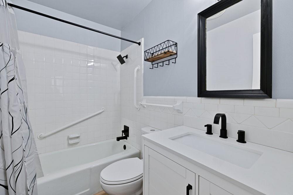 2716 Wayside Avenue Fort Worth, TX 76110 - Photo 23 of 34 a bathroom with a sink a toilet and shower
