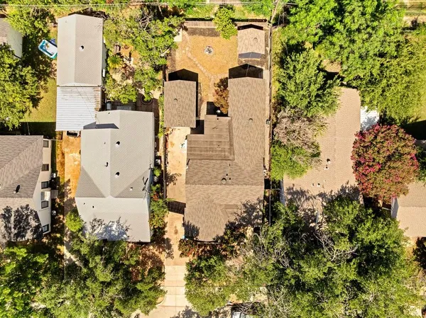 an aerial view of a house with a yard