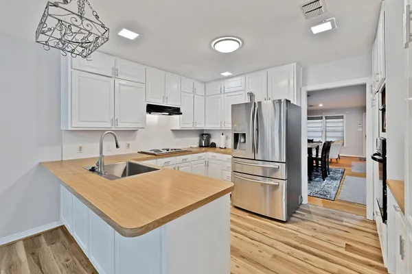 a kitchen with a refrigerator and a sink