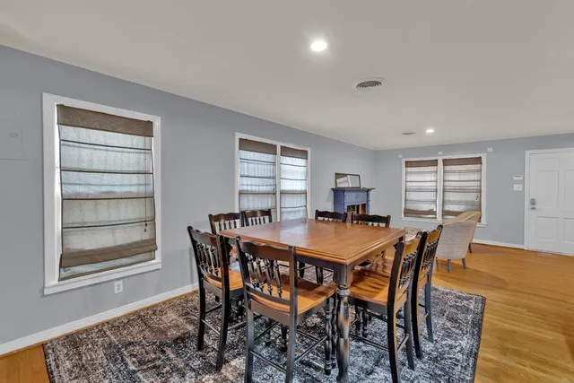 a dining room with a wooden table and chairs