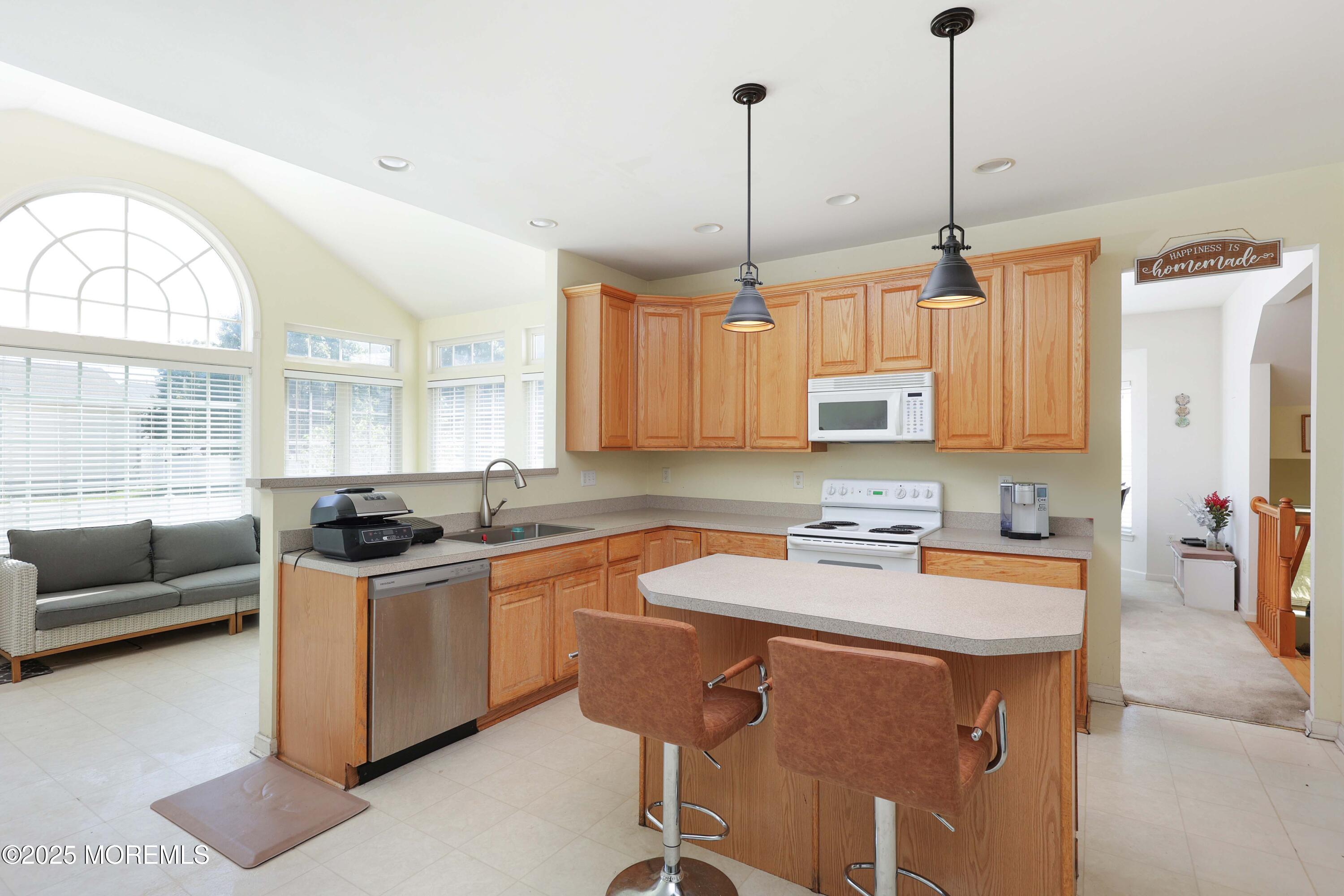 32 Firestone Drive Howell, NJ 07731 - Photo 11 of 43 a kitchen with stainless steel appliances granite countertop a stove a sink a refrigerator a counter space and a center island