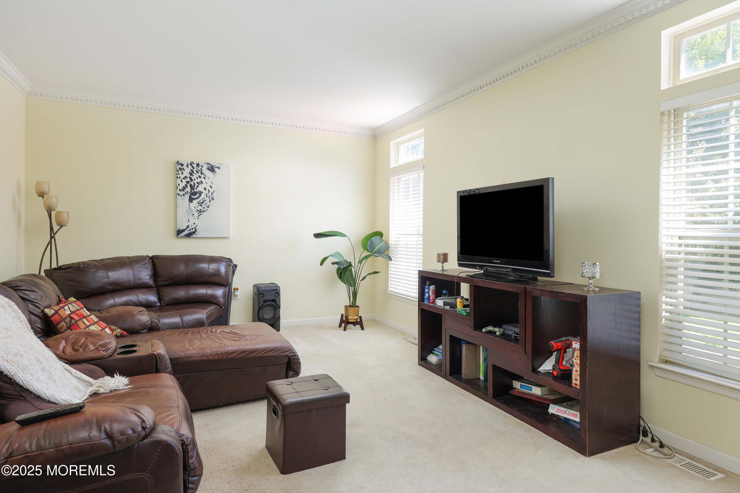 32 Firestone Drive Howell, NJ 07731 - Photo 15 of 43 a living room with furniture and a flat screen tv