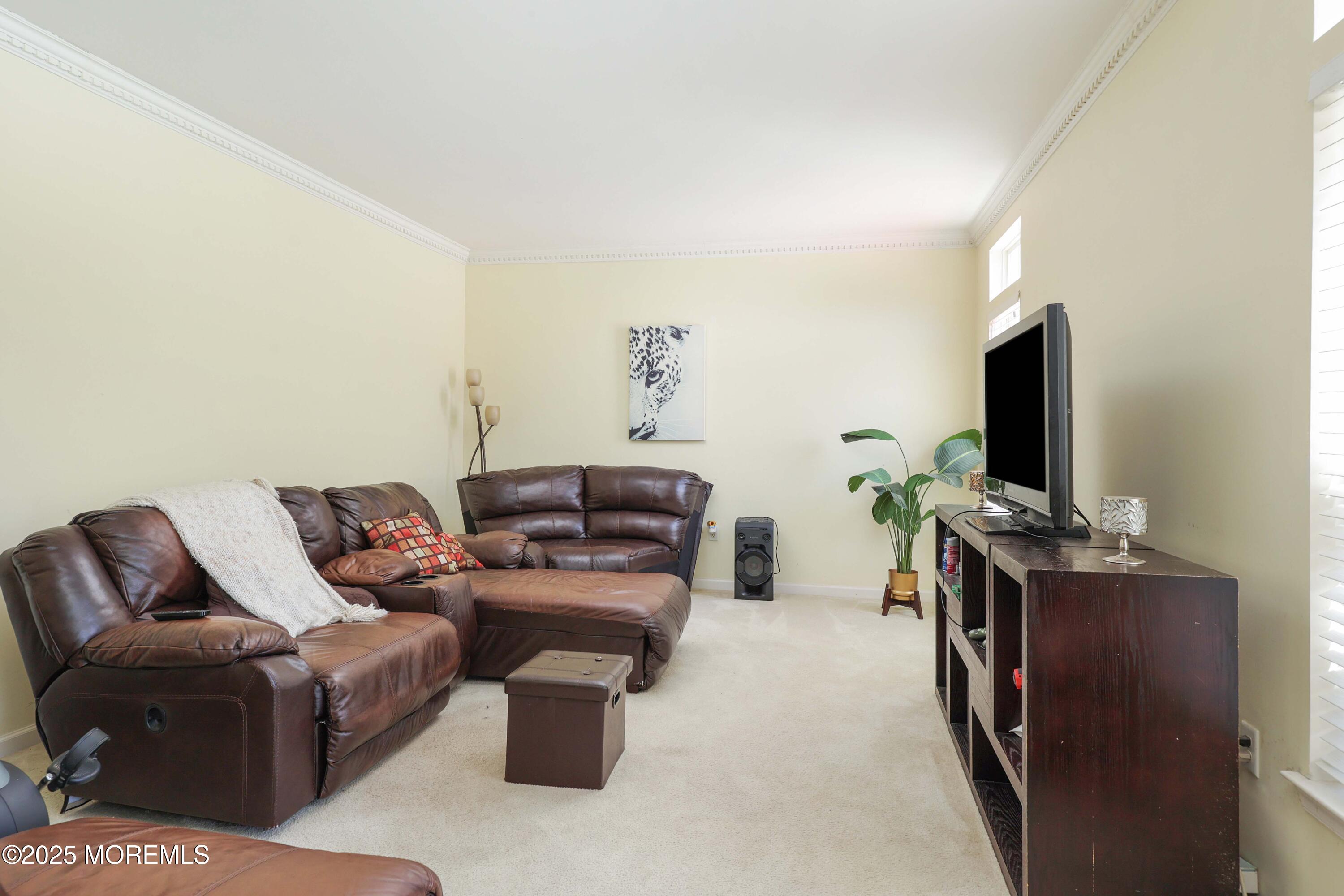 32 Firestone Drive Howell, NJ 07731 - Photo 16 of 43 a living room with furniture and a flat screen tv