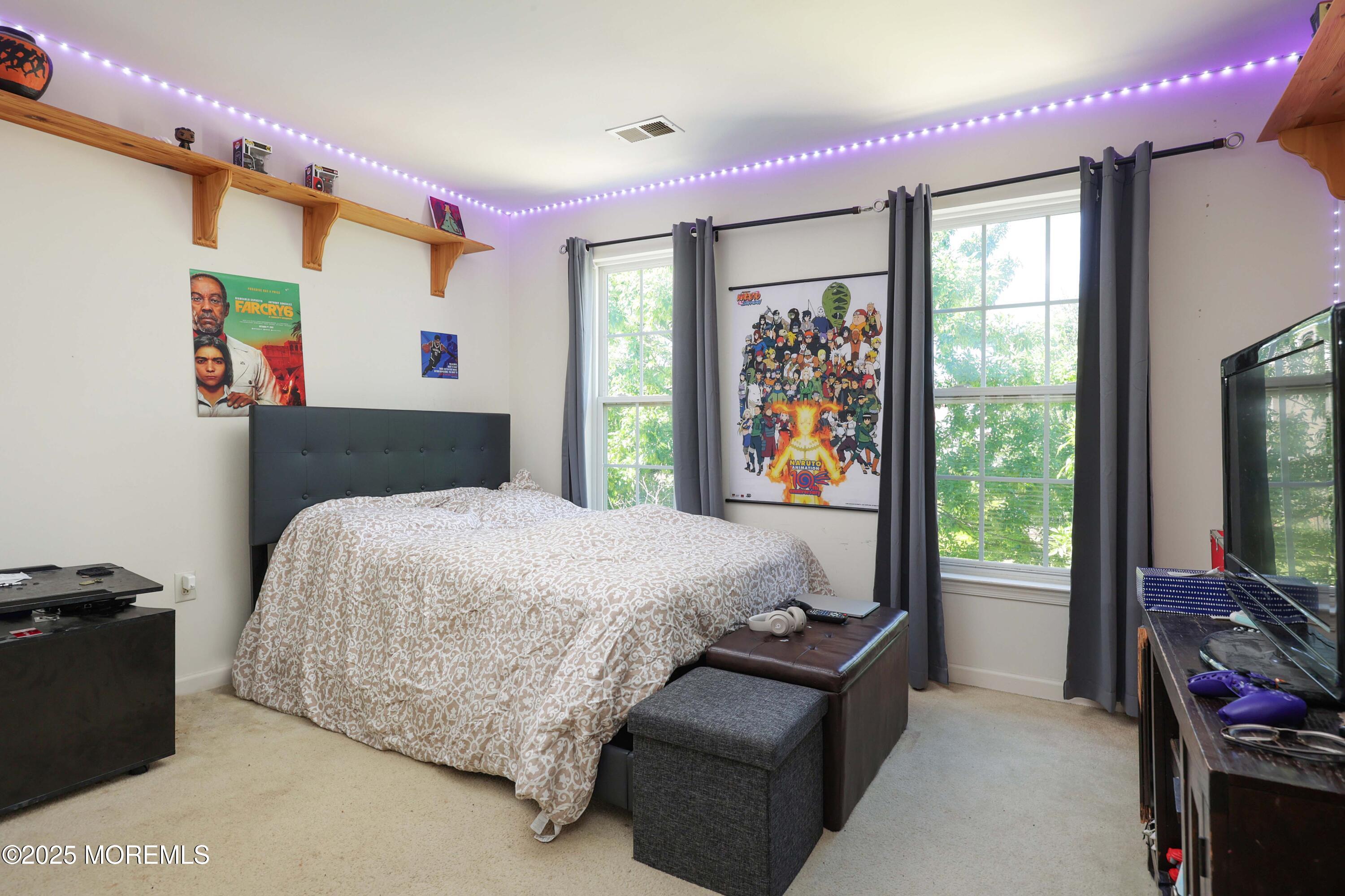 32 Firestone Drive Howell, NJ 07731 - Photo 18 of 43 a bedroom with a bed and a dresser next to a window