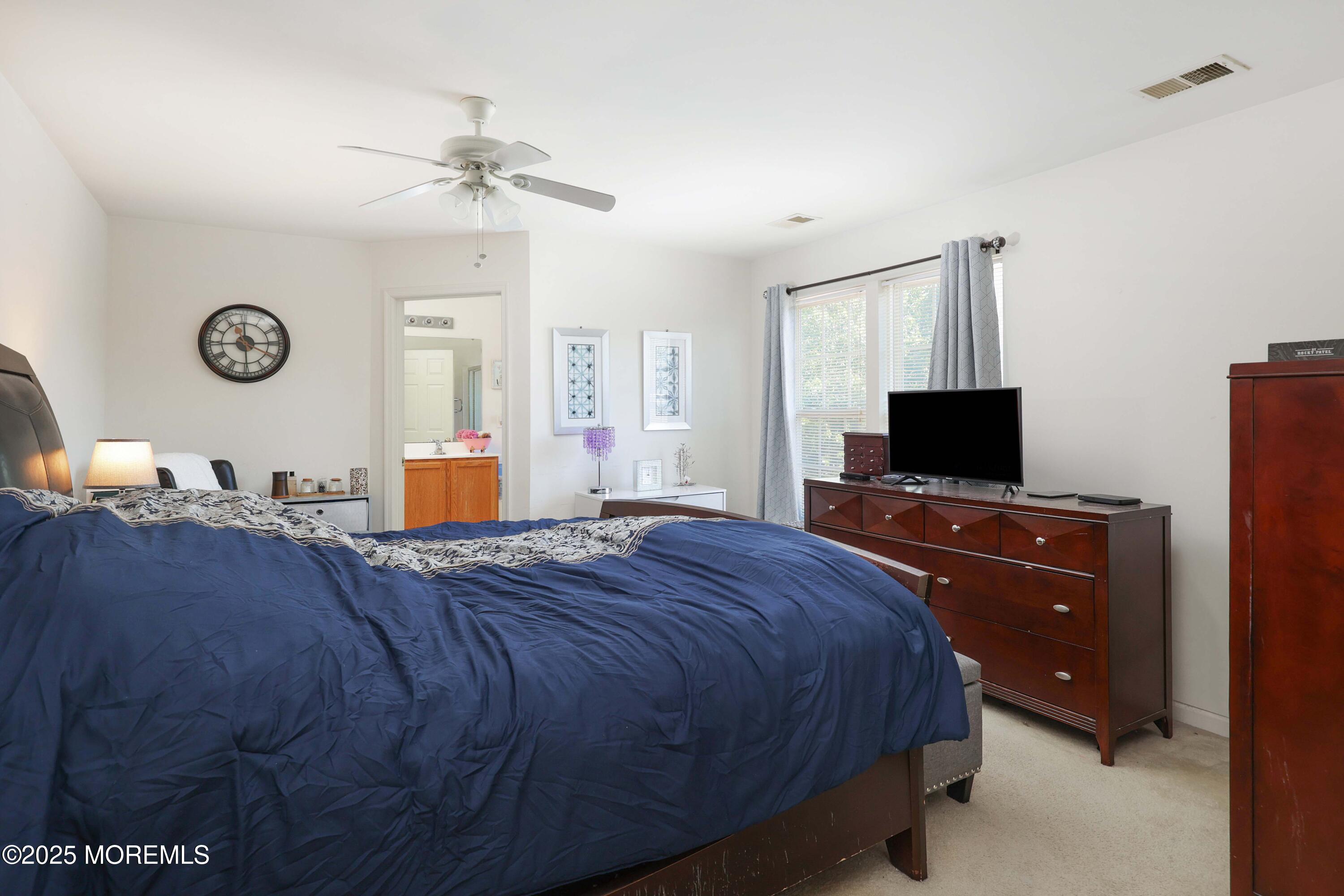 32 Firestone Drive Howell, NJ 07731 - Photo 21 of 43 a bedroom with a bed and a flat screen tv